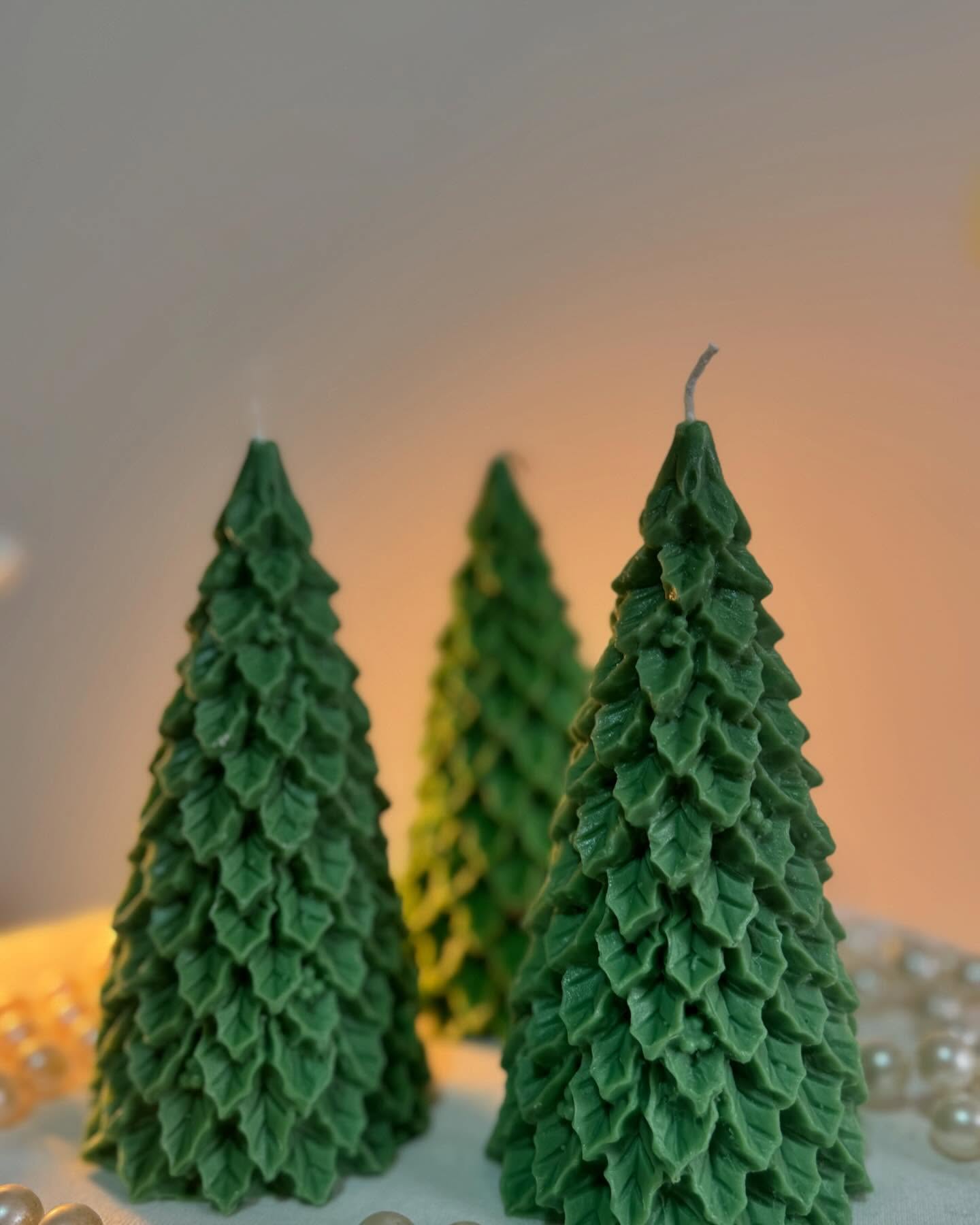 Three green evergreen tree candles